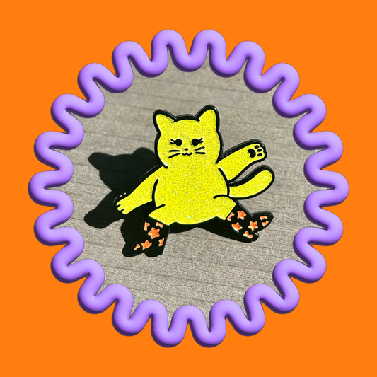 Showbiz Baby enamel pin featuring a glittery cat with boots
