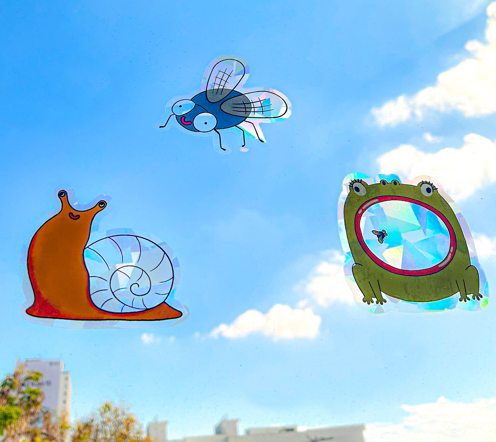 Snail suncatcher on sunny window casting colorful rainbow reflections
